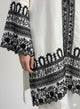 White dress with black intricate patterns on a white background